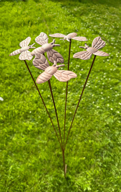 Rustic metal bee garden stake displayed outdoors as decorative pollinator themed garden ornament for flower beds
