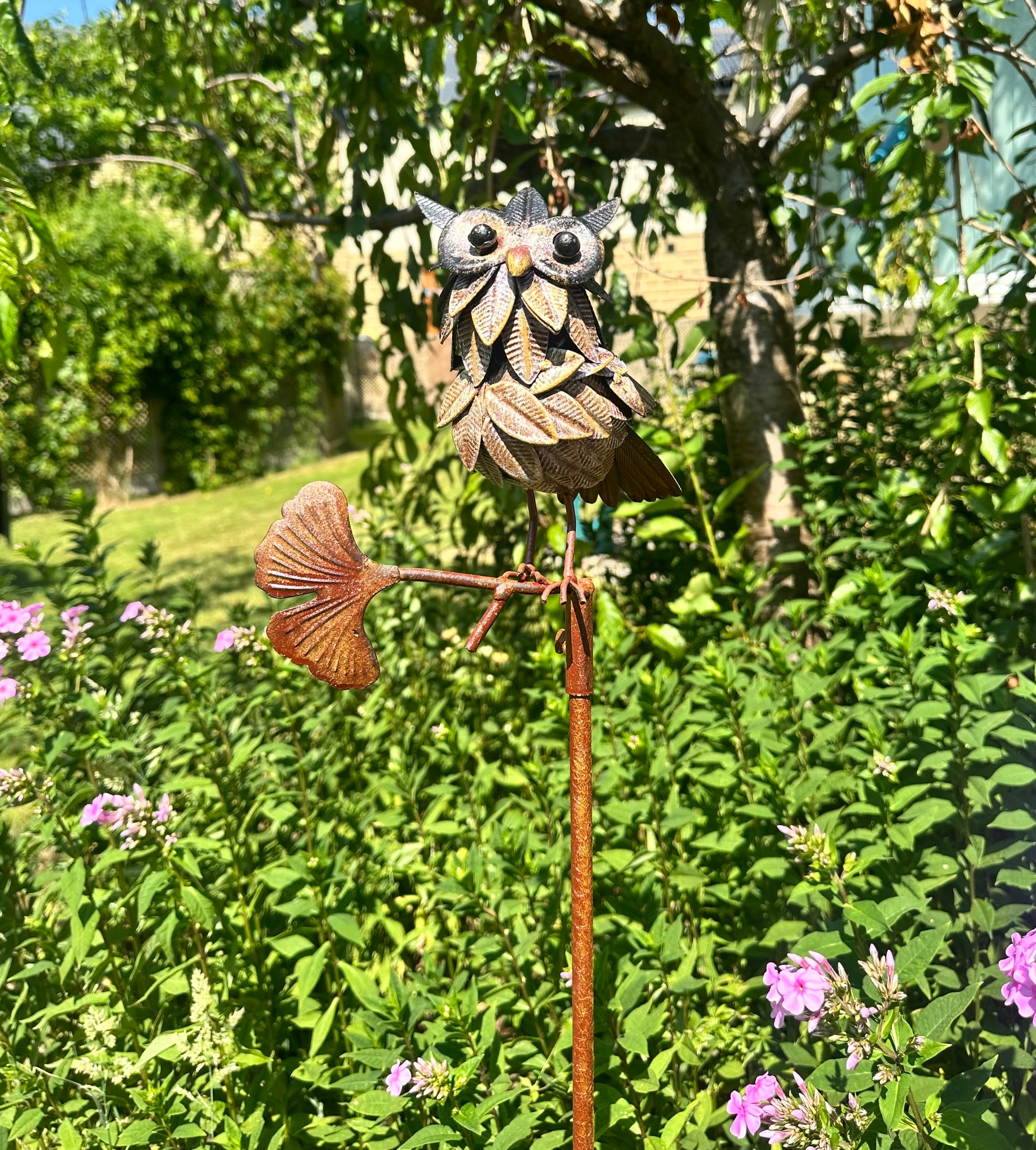 Rustic metal owl garden stake ornament with detailed feather design for outdoor garden decor and planter styling