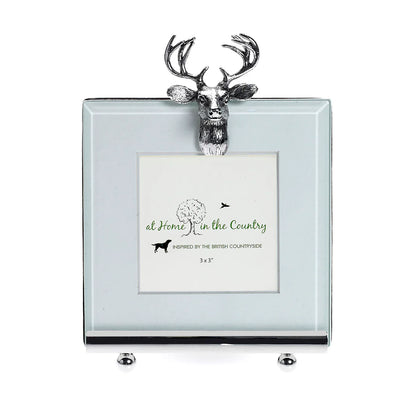silver photo frame with a stag emblem on the top 