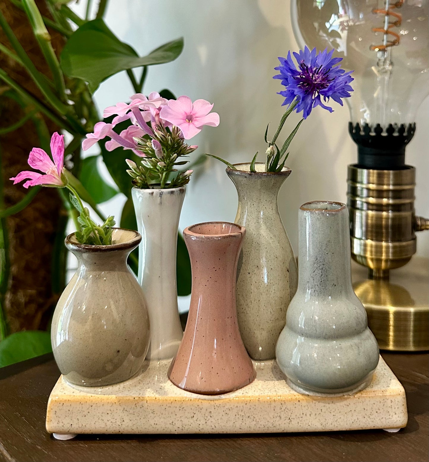 Neutral-tone mini vases on a shared base for rustic display or thoughtful gift

