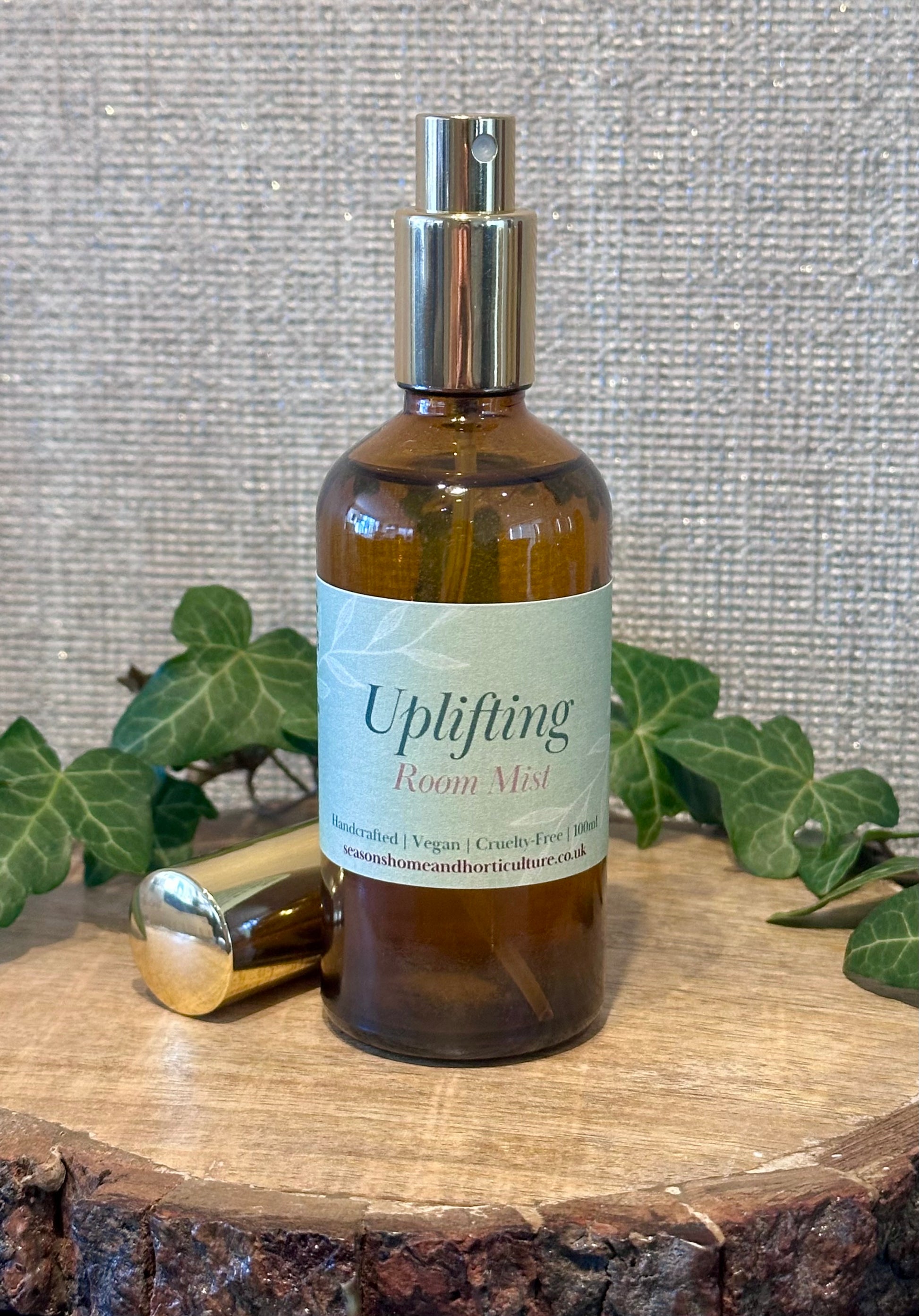 Uplifting essential oil room mist in an amber spray bottle from the apothecary range with basil, spearmint, mandarin, patchouli, and ylang ylang for energising home fragrance and wellness gifts