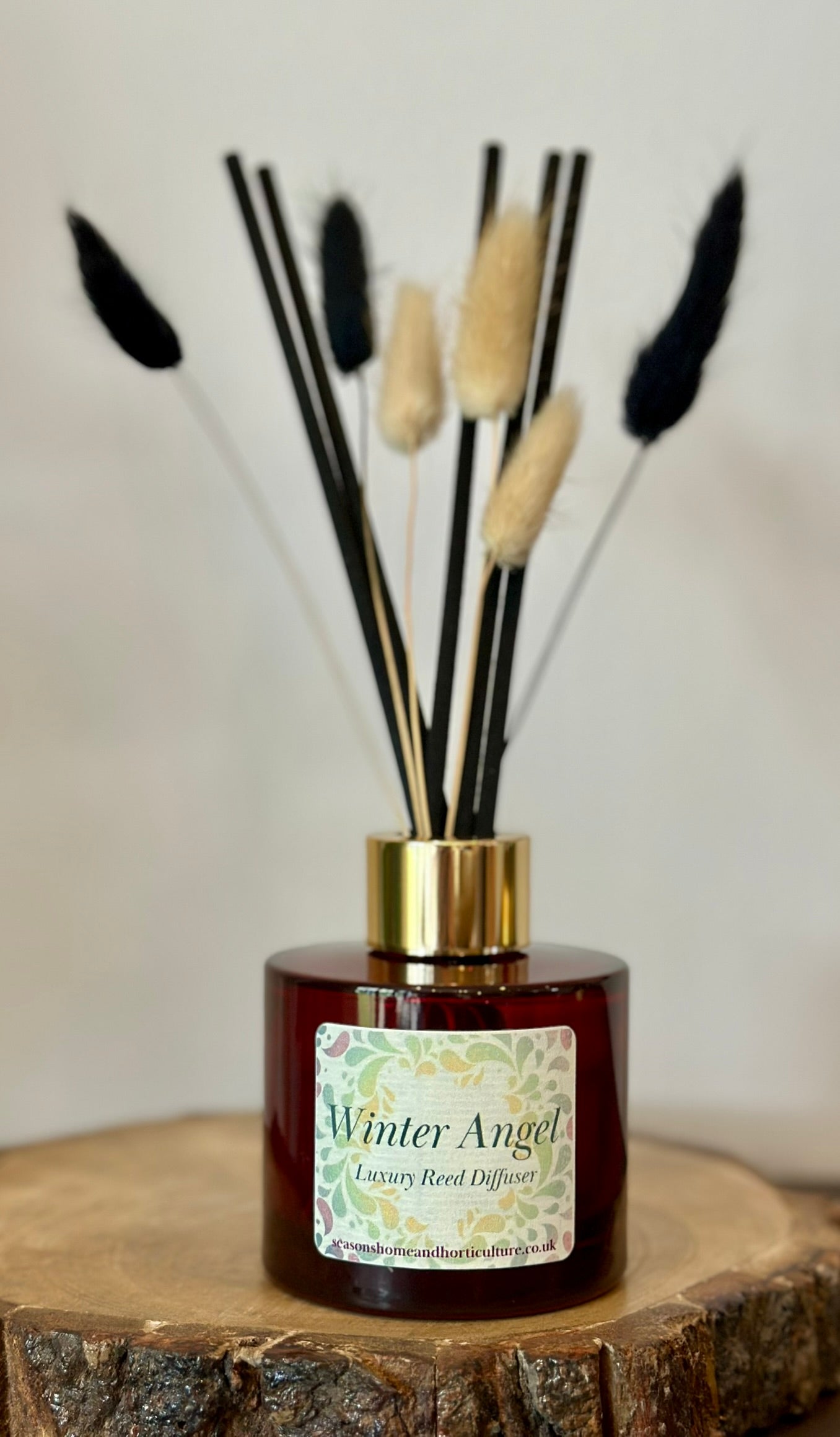 Winter Angel luxury reed diffuser with jasmine, amberwood, and saffron fragrance, vegan and cruelty-free festive home scent gift.
